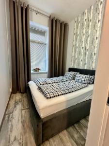 a small bedroom with a bed with a window at Royal City Centre Apartment - 2 Bedrooms 72 m2 - AC - Balcony - Coffee Machine - Washer - Dryer -Parking available Free public or Paid Private for 20 euro per stay Please read our emails in Poprad