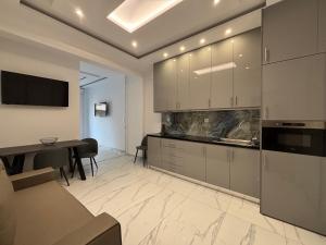 a kitchen with a table and a dining room at The Onyx Residence in Loutraki