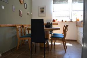 a dining room with a wooden table and chairs at Lakuša Retreat in Latin