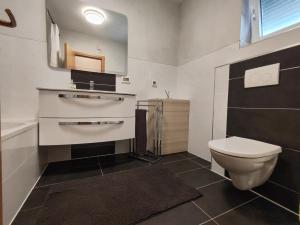 a bathroom with a toilet and a sink at Kata 2 in Ližnjan +6 photos