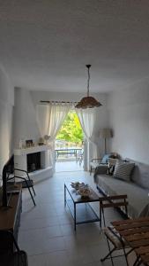 a living room with a couch and a table at Bright & Bloom maisonette in Hanioti