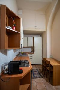 a kitchen with a counter and a kitchen with a sink at Casa di Alfredo Affittacamere in Siena
