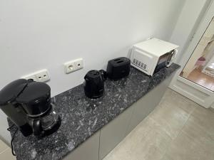 a kitchen counter with a coffee maker and a microwave at HondaMar in Playa Honda