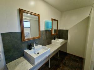 a bathroom with two sinks and a mirror at Zula Lodge in Wanaka +52 photos