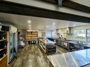 a large kitchen with wooden floors and stainless steel appliances at Zula Lodge in Wanaka