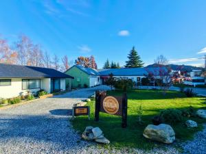 a welcome sign in front of a house at Zula Lodge in Wanaka
