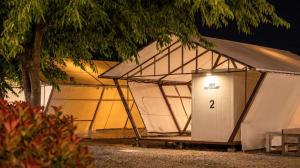 a row of tents with a door in the middle at Taean Bibi ArtGlamping in Taean