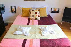 a bed with two towels on top of it at Villa Penim - Countryside Villa with Jacuzzi, Garden with BBQ & Stunning Views in Sesimbra