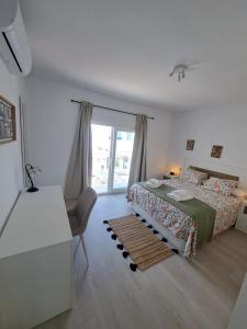 a bedroom with a bed and a desk and a window at Davinia apartamento centro in Nerja
