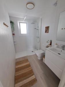 a white bathroom with a sink and a toilet at Davinia apartamento centro in Nerja +32 photos