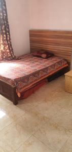a bed with a wooden frame in a room at Bethany in Riche Bois