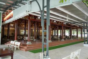 a pavilion with tables and chairs in a building at Mekong Hotel in Tây Ninh