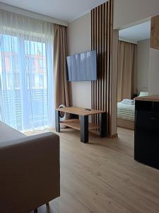a hotel room with a table and a bed at Morski Klimat in Jastrzębia Góra