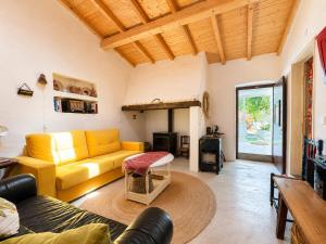 a living room with a yellow couch and a fireplace at Casa de Benavila in Benavila