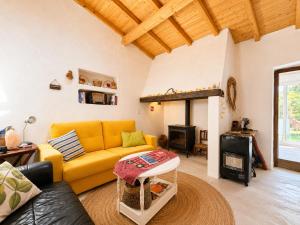 a living room with a yellow couch and a fireplace at Casa de Benavila in Benavila