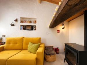a yellow couch in a living room with a fireplace at Casa de Benavila in Benavila