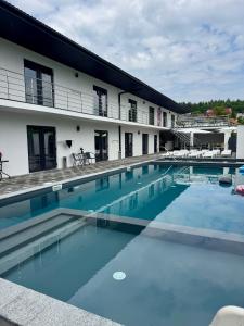a large swimming pool in front of a building at Hotel Elena Solotvino in Solotvyno