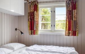 a bedroom with a bed and a window at Uplandhytta in Ringsaker