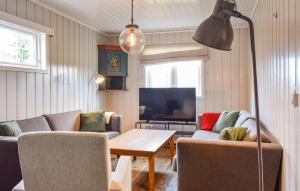 a living room with a couch and a table at Uplandhytta in Ringsaker