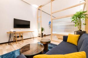 a living room with a couch and a table at Tien Hotel Georgetown in George Town