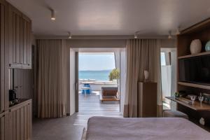 a hotel room with a bed and a view of the ocean at Santana Beach in Agia Anna Naxos +80 photos