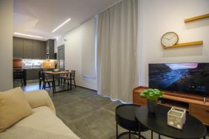 a living room with a couch and a table at MarGio Olive House in Galissas