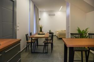 a dining room with tables and chairs and a couch at MarGio Olive House in Galissas