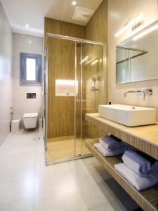 a bathroom with a sink and a shower at MarGio Olive House in Galissas +13 photos