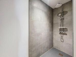 a bathroom with a shower with a shower head at Appartement 4 personnes in Cholet