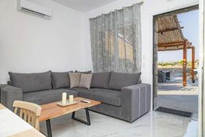 a living room with a couch and a table at Dreamy Charaki 2 Bd Villa with Private Pool in Haraki