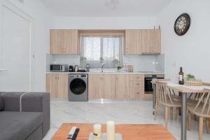 a kitchen and living room with a couch and a table at Dreamy Charaki 2 Bd Villa with Private Pool in Haraki +36 photos