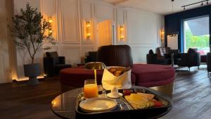 a hotel room with a tray of food on a table at Hotel Nare in Boppard