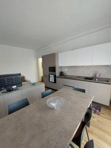 a kitchen with a table and chairs in a room at Il Lago di Luciana in Intra