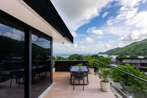 a patio with a table and chairs on a balcony at CASA MIA - Luxury Apartments Central Kuta in Kuta Lombok