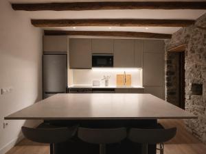 a kitchen with a large table in a room at Jaca Stone in Banaguás