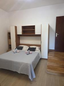 a bedroom with a bed with two pillows on it at Brane Apartmani in Zadar