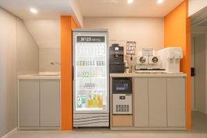 a kitchen with a refrigerator with drinks in it at No25 Hotel Chuncheon Cityhall in Chuncheon