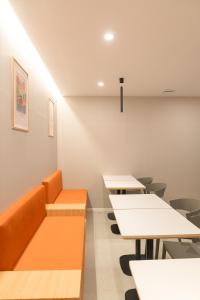 a classroom with desks and tables and chairs at No25 Hotel Chuncheon Cityhall in Chuncheon