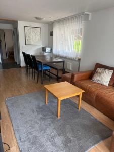 a living room with a couch and a table at Eldorado 47 grosse Wohnung mit Wunderschönen Aussicht in Leukerbad