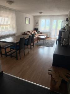 a living room with a table and chairs and a couch at Eldorado 47 grosse Wohnung mit Wunderschönen Aussicht in Leukerbad