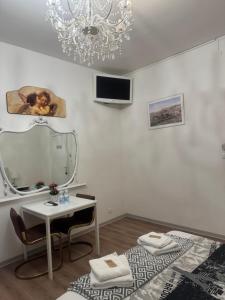 a white room with a table and a mirror at Firenze inn 21 Florence in Florence +28 photos