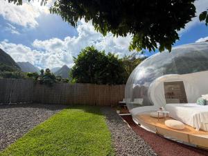 a bedroom in a glass dome in a backyard at Entre 2 bulles in Entre-Deux