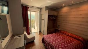 a bedroom with a red bed and a window at Albergo Ristorante Monterosa in Ameno +45 photos