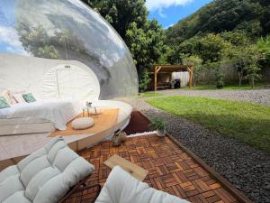 a bedroom in a dome with a bed and a table at Entre 2 bulles in Entre-Deux