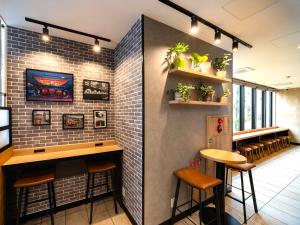 a bar with stools and a brick wall at Super Hotel Akihabara Suehirocho in Tokyo