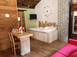 a room with a bed and a table in it at borgo maira village in Prazzo