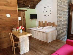 a room with a bed and a table in it at borgo maira village in Prazzo