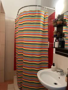 a shower curtain in a bathroom with a sink at Vicente Apartment in Skala Rachoniou +14 photos
