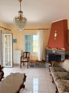 a living room with a fireplace and a couch at Molyvos Sunset Horizon in Mythimna