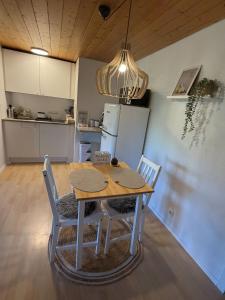 a kitchen and dining room with a table and chairs at Ferienhaus am Bächle in Breitnau